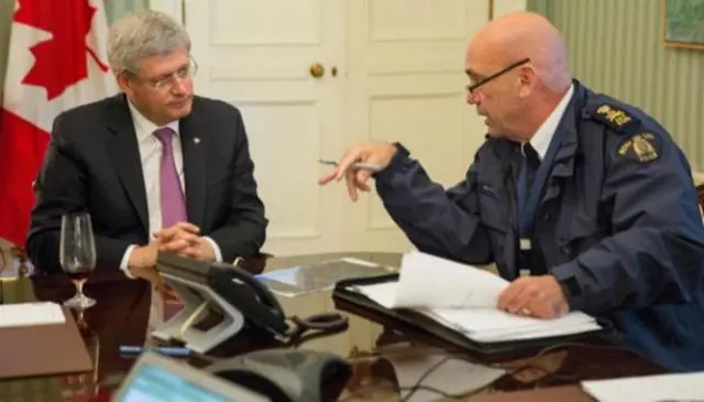 Prime Minister Harper being briefed by the RCMP commissioner Bob Paulson