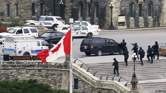 Armed police approach Centre Block on Parliament Hill, Ottawa. 22 Oct 2014