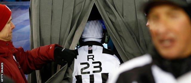 An official inside the stadium views a replay on the side of the pitch