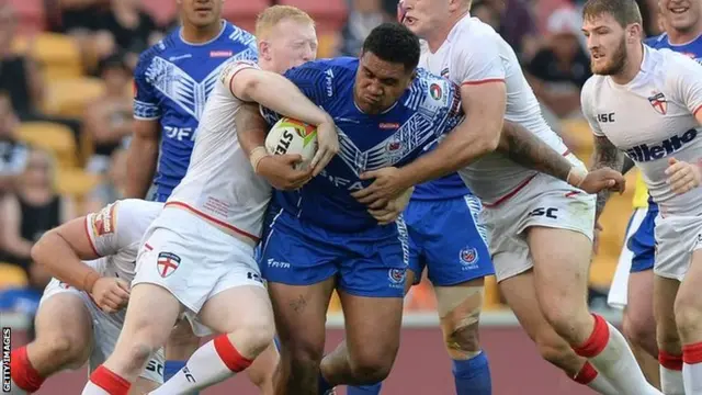 Mose Masoe of Samoa is tackled