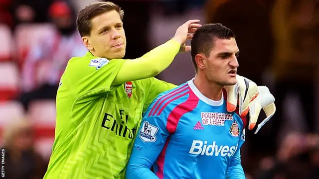 Goalkeeper Vito Mannone of Sunderland is consoled by opposite number Wojciech Szczesny of Arsenal