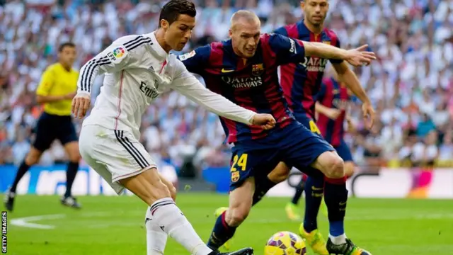 Cristiano Ronaldo and Jeremy Mathieu vie for the ball