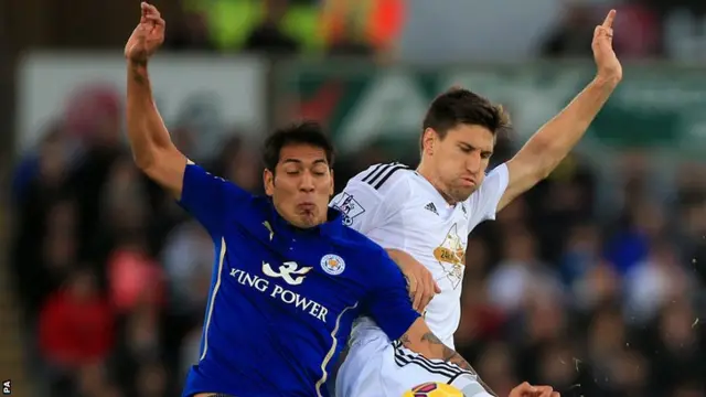 Leonardo Ulloa challenges for the ball