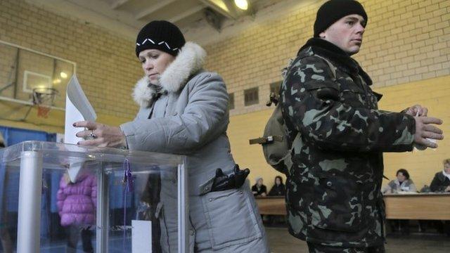 Ukrainian voters cast their ballots at a polling station during parliamentary elections in Kiev