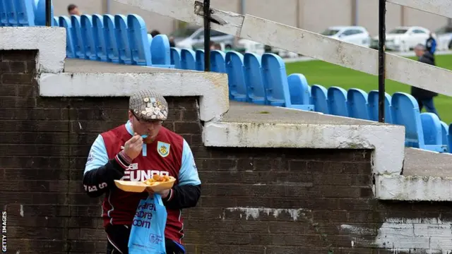 Burnley fan eating before Everton game