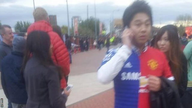 A supporter wears a kit with one half Chelsea and one half Manchester United