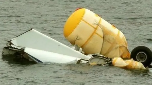 Helicopter wreckage being salvaged