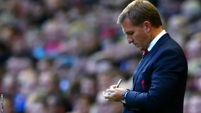 Liverpool manager Brendan Rodgers takes notes