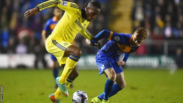 Chelsea's Didier Drogba holds off Shrewsbury's Ryan Woods