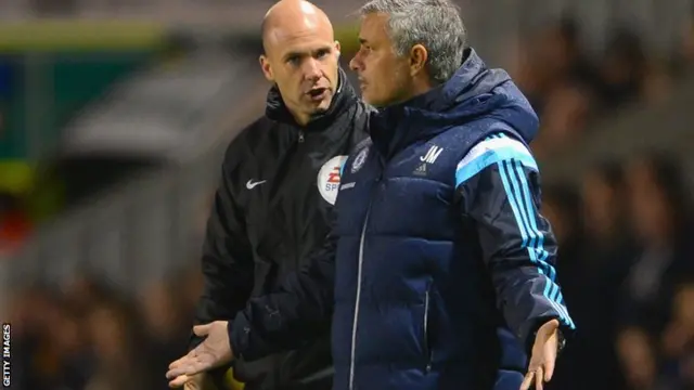 Chelsea boss Jose Mourinho talks to the fourth official