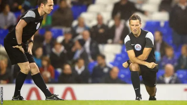 Referee Mark Clattenburg warms up for Tottenham v Brighton