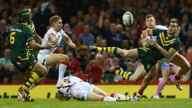 Greg Inglis of Australia passes to set up his sides first try scored by Johnathan Thurston (L) as Kevin Sinfield and Sam Tomkins of England fail to tackle during the 2013 rugby league World Cup