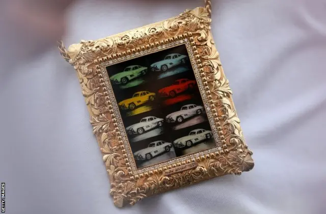 Lewis Hamilton's chain displaying an image of Andy Warhol"s "Cars, Mercedes Benz 300 SL Coupe"