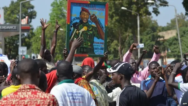 Crowds carrying posters of Thomas Sankara, the late president of Burkina Faso, 29 October 2014