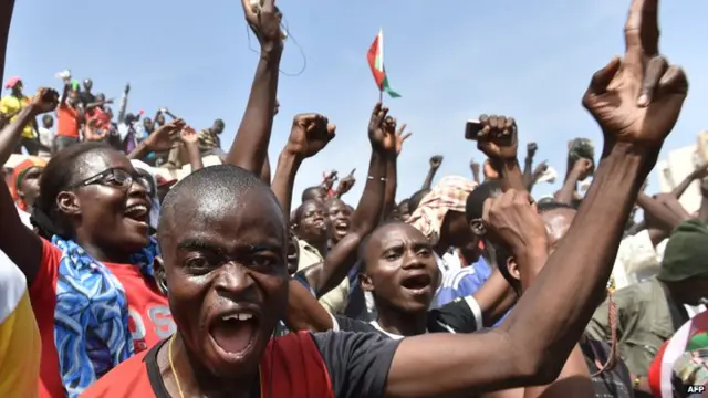 People celebrate in the capital Ouagadougou after Burkina Faso"s embattled President Blaise Compaore announced earlier on October 31, 2014