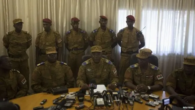 Burkina Faso's military chief General Honore Traore (centre) speaks at a news conference announcing his takeover of power at the army headquarters in Ouagadougou, capital of Burkina Faso, 31 October 2014