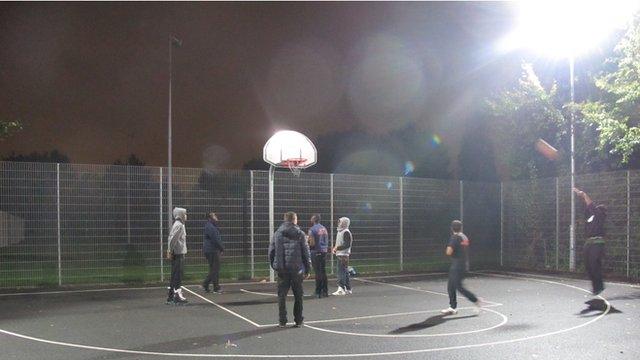 Young people play basketball