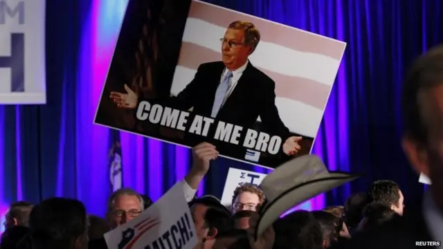 Supporter of Mitch McConnell (R-KY) raises sign at his mid-term election night rally in Louisville, Kentucky