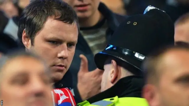 CSKA Moscow fan talks to police officer