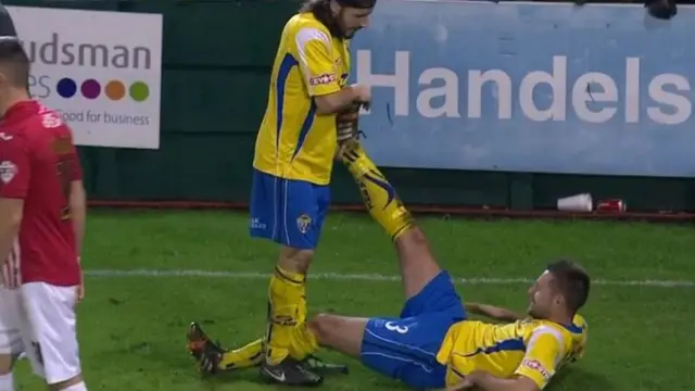 Tom Hardwick receives treatment from a teammate for cramp