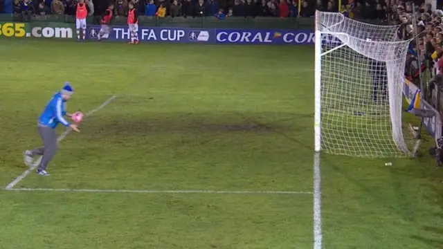 A bobble-hatted gentleman nipping on to the pitch to clear a stray ball