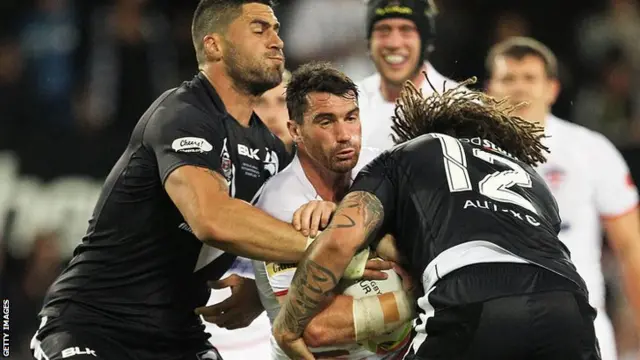 England's Matty Smith takes a heavy tackle