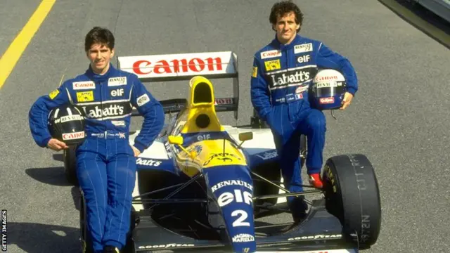 Damon Hill & Alain Prost sit on a Williams F1 car in 1993