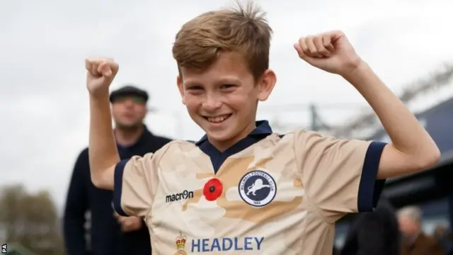 A young fan in Millwall's commemorative shirt