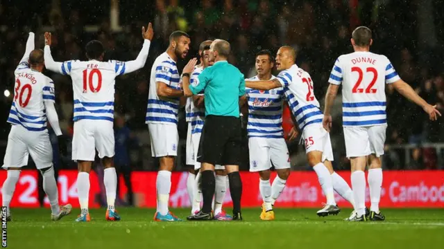 QPR remonstrate with the referee