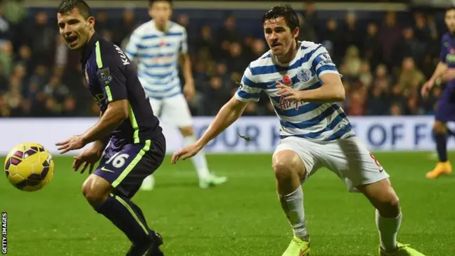 Sergio Aguero and Joey Barton fight for the ball