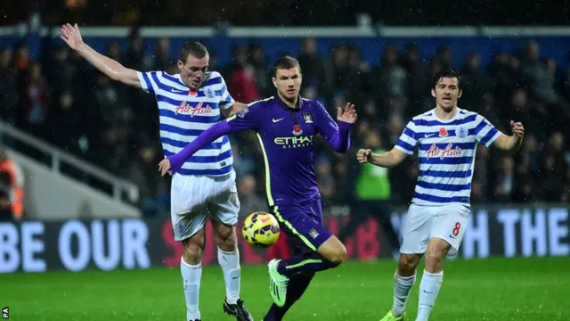 Edin Dzeko challenges for the ball