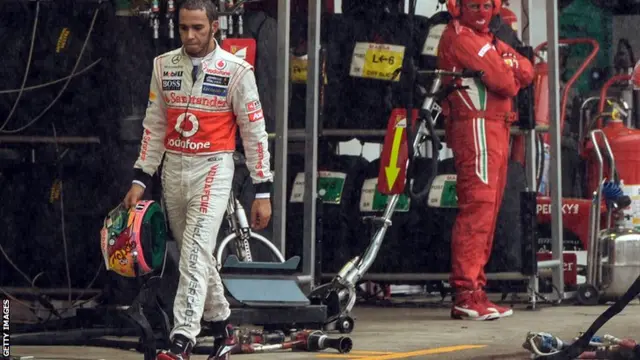 British Formula One driver Lewis Hamilton walks in the pits of Interlagos race track, on November 25, 2012 in Sao Paulo, Brazil.