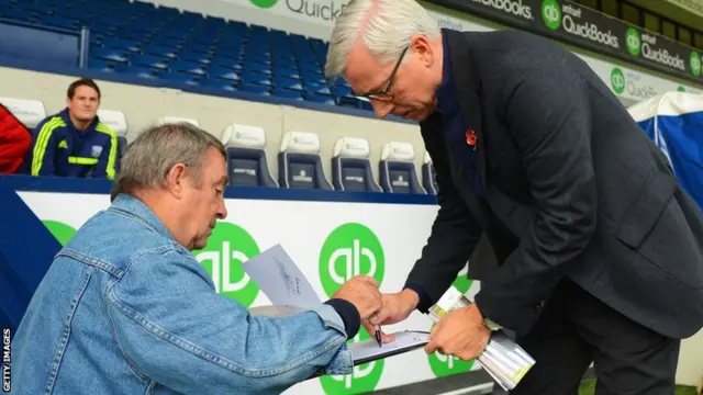 Newcastle United manager Alan Pardew signs an autograph