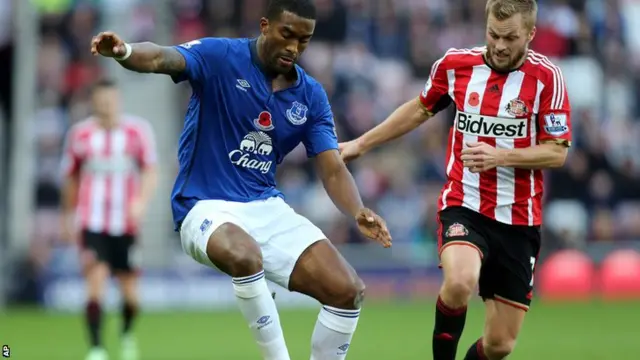 Sylvain Distin is challenged for the ball by Sunderland