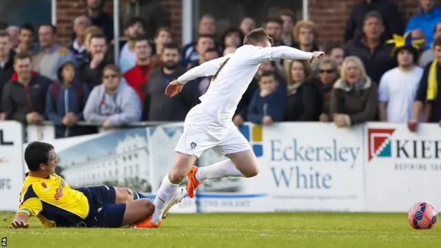 Colchester's Freddie Sears is brough down for a penalty