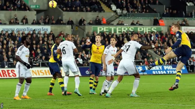 Per Mertesacker heads towards goal