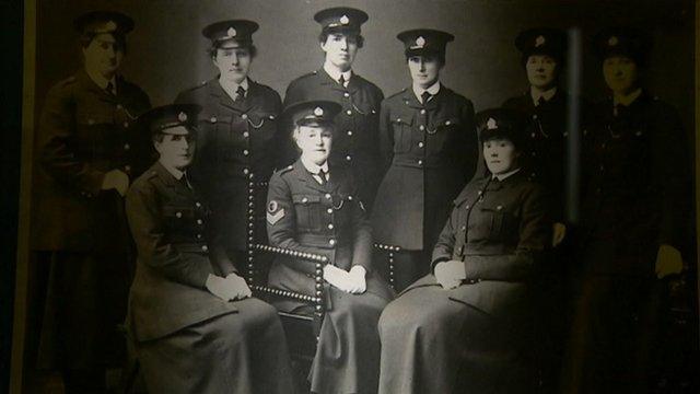 Women police officers sitting down wearing long skirts
