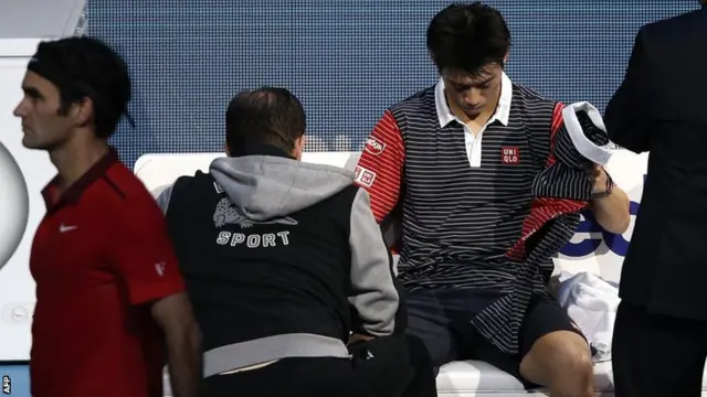 Nishikori gets treatment on his right wrist against Roger Federer in his previous match