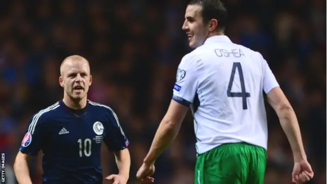 Steven Naismith looks on at opponent John O'Shea