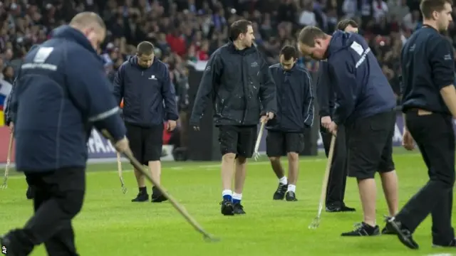 Grounds men fork the pitch