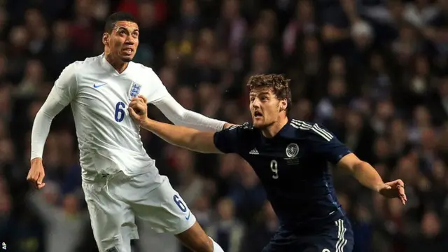 England defender Chris Smalling takes on Scotland's Chris Martin