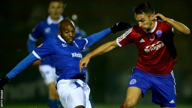 Portsmouth's Nigel Atangana tackles Aldershot's Brett Williams