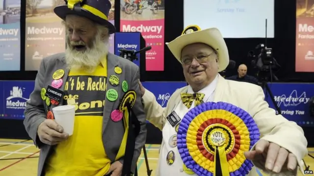 The leader of the Official Monster Raving Loony Party, Howling Laud Hope (right)