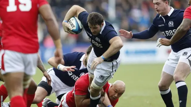 Scotland"s Johnnie Beattie is tackled by Tonga"s Tevita Mailau