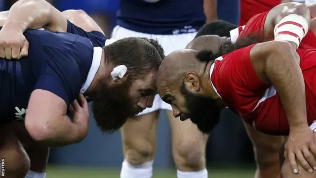 Scotland"s Geoff Cross (L) and Tonga"s Tevita Mailau get ready for a scrum