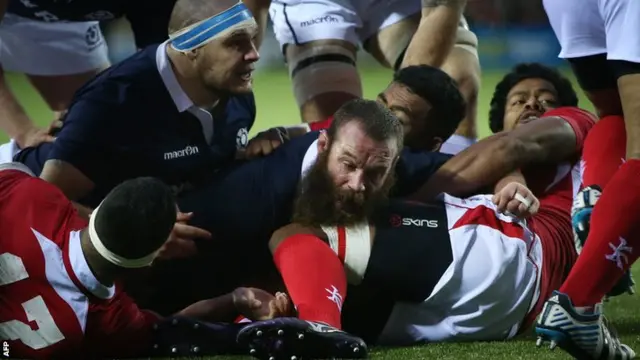 Scotland"s Geoff Cross scores a try