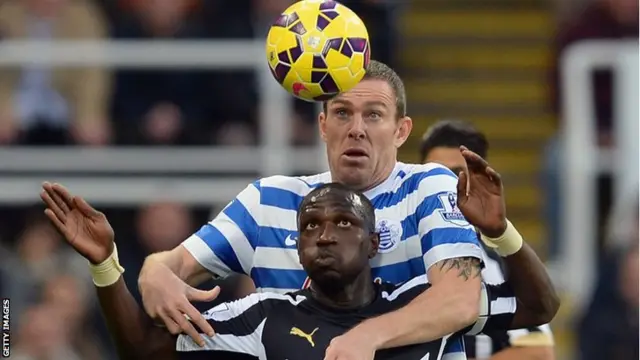 QPR captain Richard Dunne eyes the ball