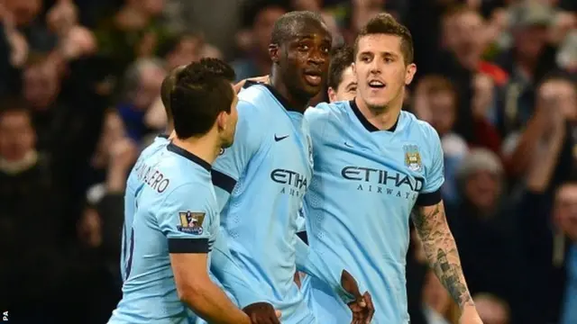 Yaya Toure celebrates with teammates