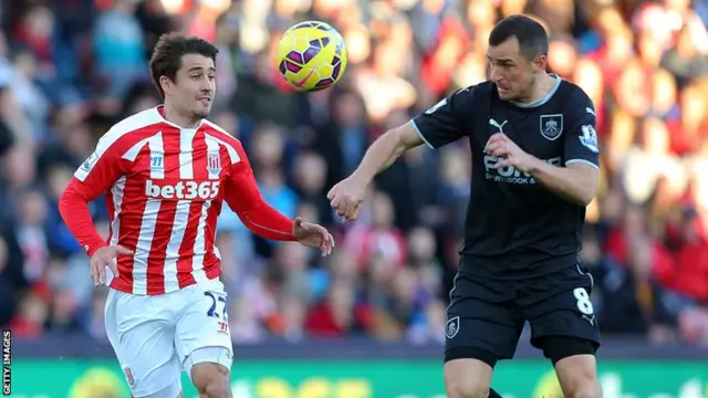 Stoke's Bojan and Burnley's Dean Marney go for the ball