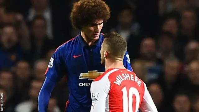 Arsenal's Jack Wilshere squares up to Manchester United's Marouane Fellaini